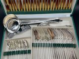 silverware in a green case with spoons and spoons in it