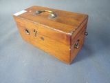 a small wooden box with a handle on a table