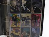 a binder with a bunch of comic books inside of it