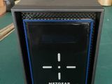 the netgear is sitting on a table with a green table cloth