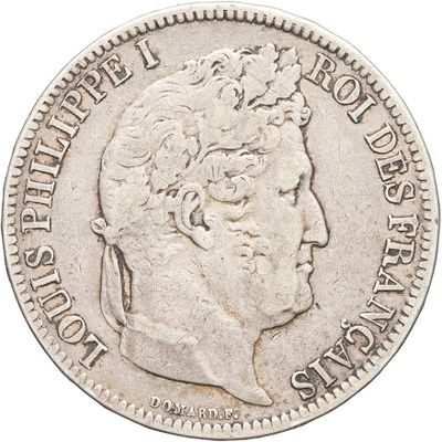 a close up of a coin with a man ' s head on it
