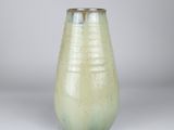 a green vase that is sitting on a table