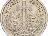 an image of a five cent coin with a knife on top of it