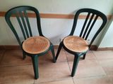 two green chairs sitting next to each other on a tiled floor