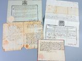 several old papers are sitting on top of a table