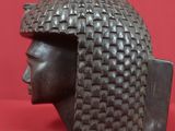 a close up of a statue of a person wearing a helmet