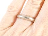 a woman ' s hand with a ring on it ' s finger