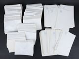 Plusieurs enveloppes blanches sont empilées les unes sur les autres sur une surface noire.