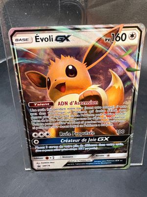 a pokemon card in a clear box on a table
