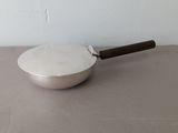 a pan with a handle sitting on a table