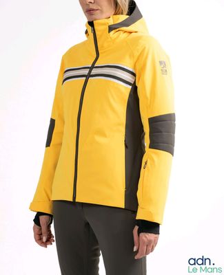 the woman is wearing a yellow jacket and black pants