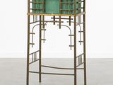 an image of a green planter sitting on top of a metal stand