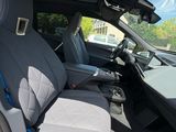 the interior of a car with a grey seat cover and a blue seat belt