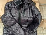 a black jacket sitting on top of a cardboard box