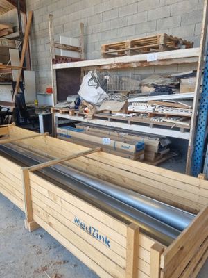 a large wooden box with a metal bar in it