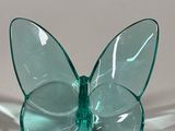 a glass butterfly that is sitting on a table