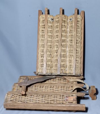 a wicker basket with a pair of scissors on it