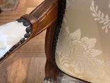 a close up of a chair with a white and black pattern on it