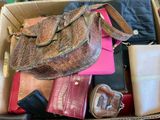 a box full of purses and wallets sitting on the floor