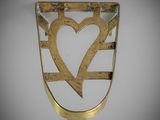a close up of a metal object with a heart on it