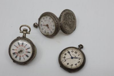 three different types of pocket watches are displayed on a white surface