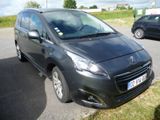 a small black car parked on the side of the road