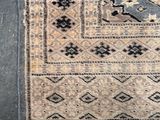 a close up of a rug on the ground with a cat laying on it