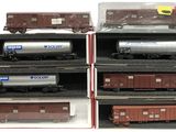 several model train cars are stacked on top of each other