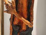 a sculpture of a man holding a stick on a table