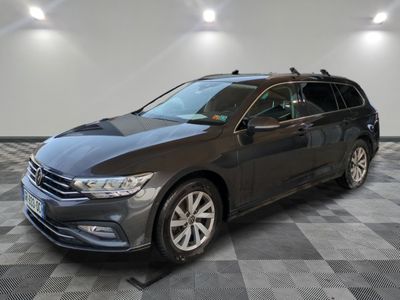 a grey volkswagen passat is parked in a room with a checkered floor