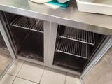 stainless steel counter top with two trays of food on it