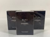 three chanel perfume bottles on a white surface with a white background