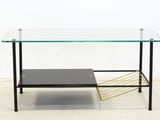 an image of a glass coffee table with a magazine rack underneath it