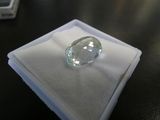 a clear diamond sitting on a white cloth on a table