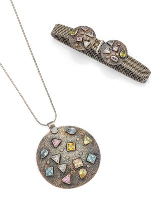 Deux bijoux sont exposés sur une surface blanche