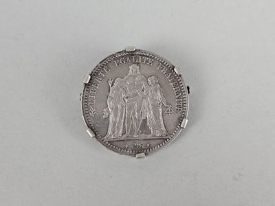 a close up of a coin on a table with a white background