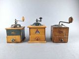 three different types of coffee grinders sitting on a table