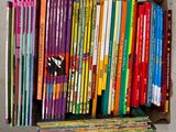 a box full of children ' s books sitting on the floor