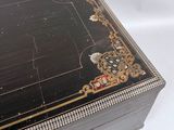 a black and gold box sitting on a white surface