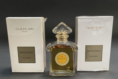 an image of a bottle of perfume next to a box of perfume
