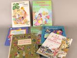 several children ' s books are lined up on a table