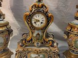 three clocks sitting on a table with a spoon next to them