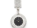 a close up of a watch on a white surface with diamonds