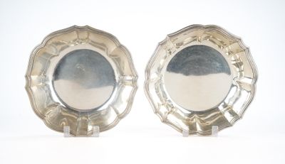 two silver plates sitting on top of each other