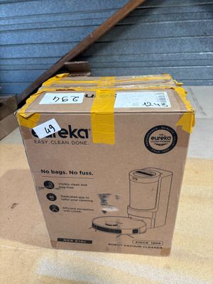 packaging of a boxed coffee maker sitting on top of a wooden floor