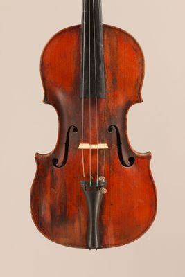 an old violin with a bow hanging from it ' s back