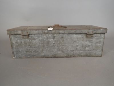 an old metal box sitting on top of a white table