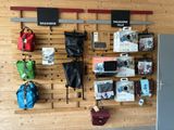 a wooden wall with a bunch of bags hanging on it