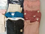 a lot of clothes that are sitting on a table