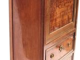 a small wooden cabinet with a marble top on it